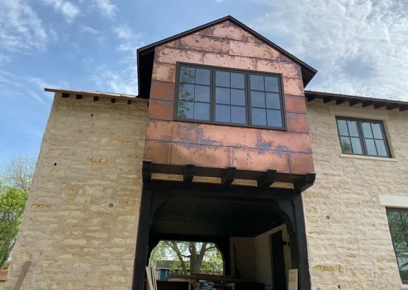 Copper metal panel facade on a stone building for Skylight Installation in Celina